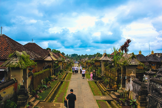 Take a stroll down the serene lanes of Penglipuran Village, captured here in its tranquil glory. As the site of the Penglipuran Festival 2023, this village exudes a timeless charm, with its traditional Balinese architecture and the lush greenery that frames the cobblestone path leading you towards a cultural journey. The alignment of the homes, each with their own intricately carved gateways and thatched roofs, speaks to the community's harmonious approach to living. The sky above, a canvas of soft blues and the promise of adventure, invites you to partake in the vibrant festivities and sustainable practices celebrated during the 'Village Festival X'—a true reflection of Bali's commitment to cultural heritage and environmental consciousness