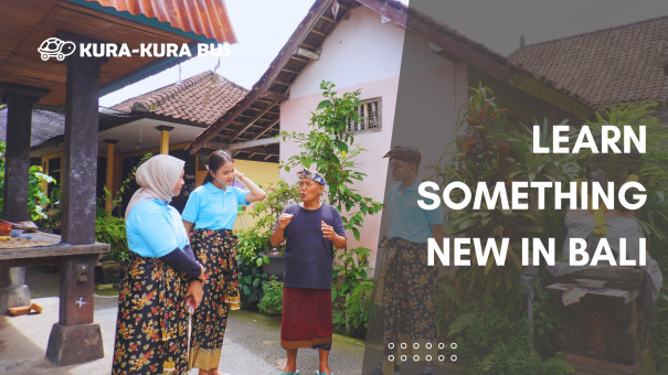 Visitors learning about Balinese culture from a local elder in a traditional Balinese compound, part of Kura-Kura Bus's educational and cultural trip in Bali.