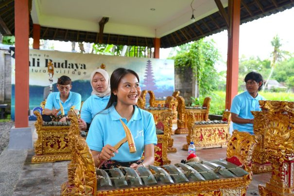 Tourists learning Balinese gamelan music during a cultural lesson in Bali