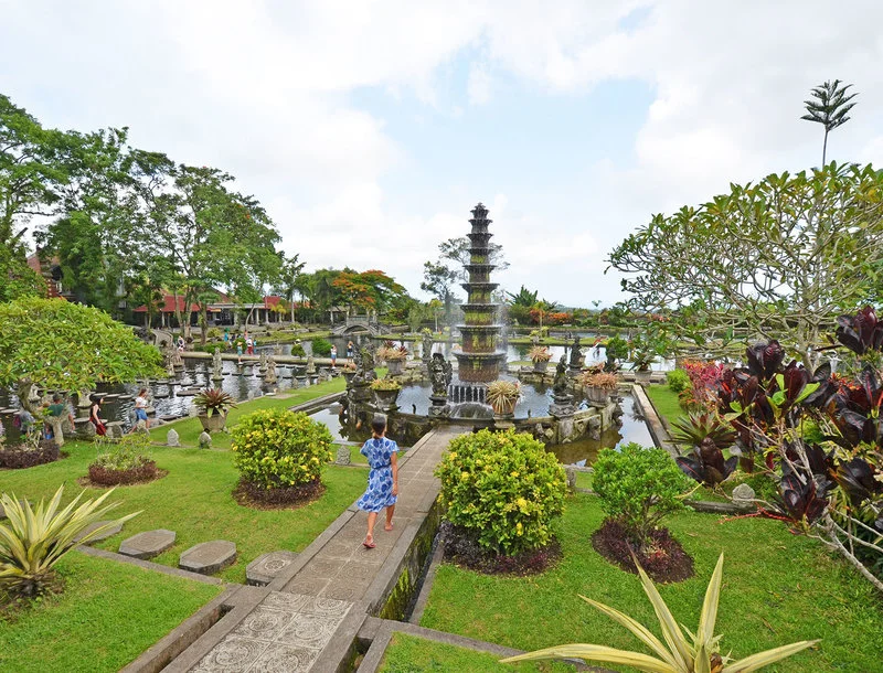 Majestic Tirta Gangga Water Palace, showcasing Balinese architecture and serene water features. Charter Car - Kura-Kura Bus