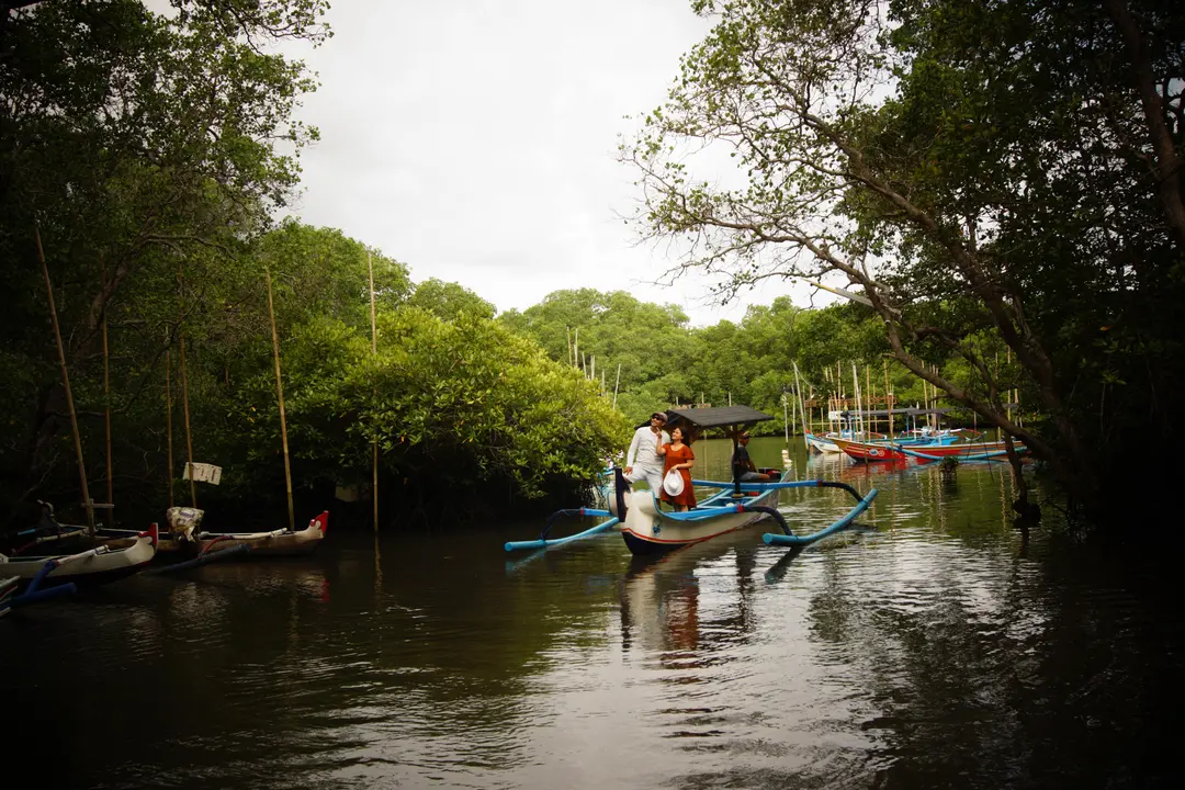 Traditional jukung boat tour through Bali mangrove forest