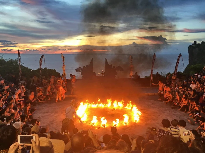 Exciting Kecak Fire Dance at Uluwatu with a beautiful sunset over the sea - Charter Car - Kura-Kura Bus
